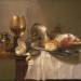 Still life of a roemer, an overturned silver tazza, a flute and a ham